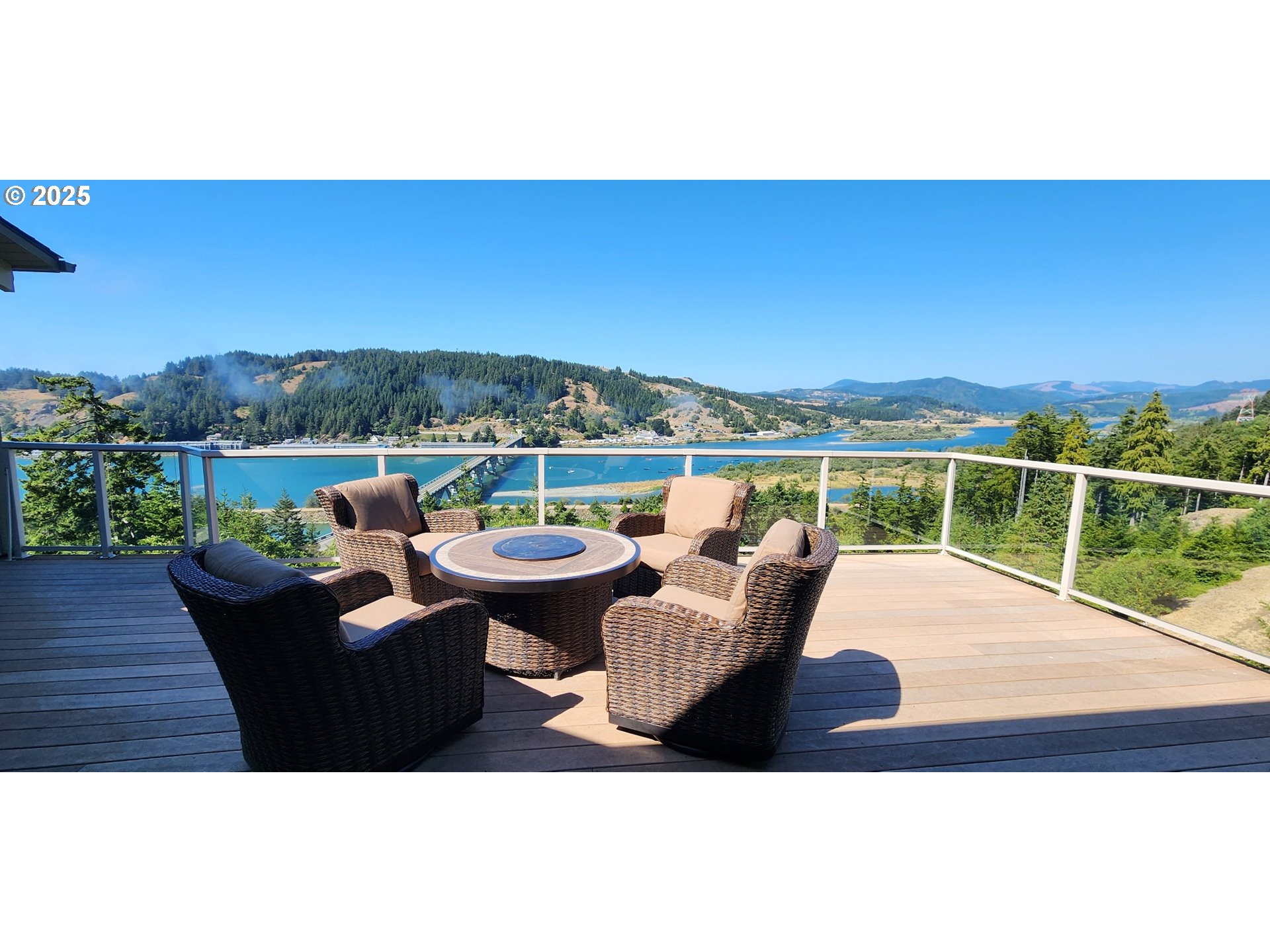 94418 Tom Cat Hill Road Gold Beach, OR 97444 - Photo 2 of 46 a view of a terrace with couches and city view