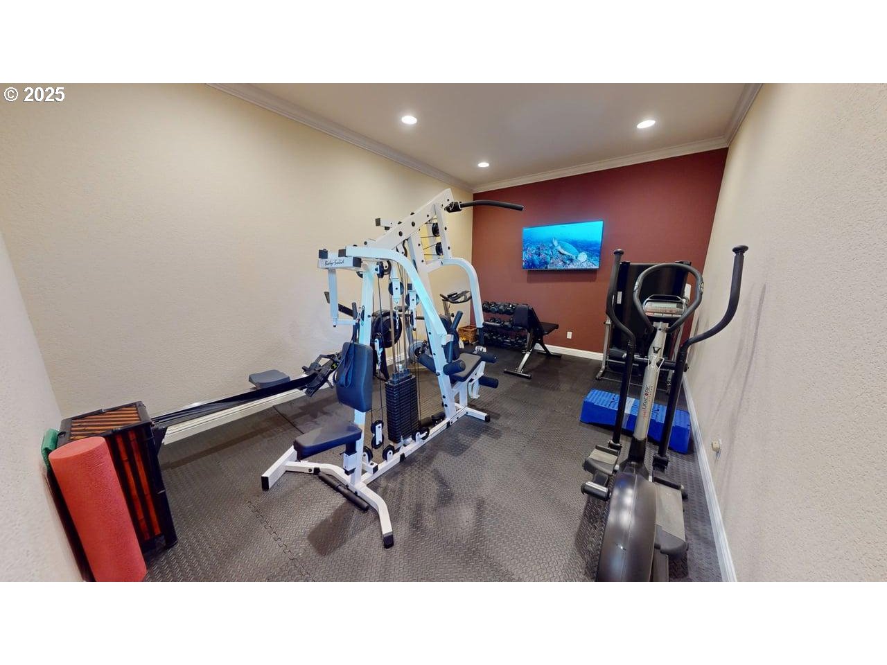 94418 Tom Cat Hill Road Gold Beach, OR 97444 - Photo 27 of 46 a room with gym equipment and a flat screen tv