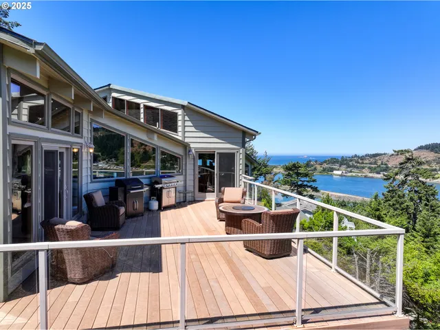 an aerial view of a house with swimming pool and ocean view