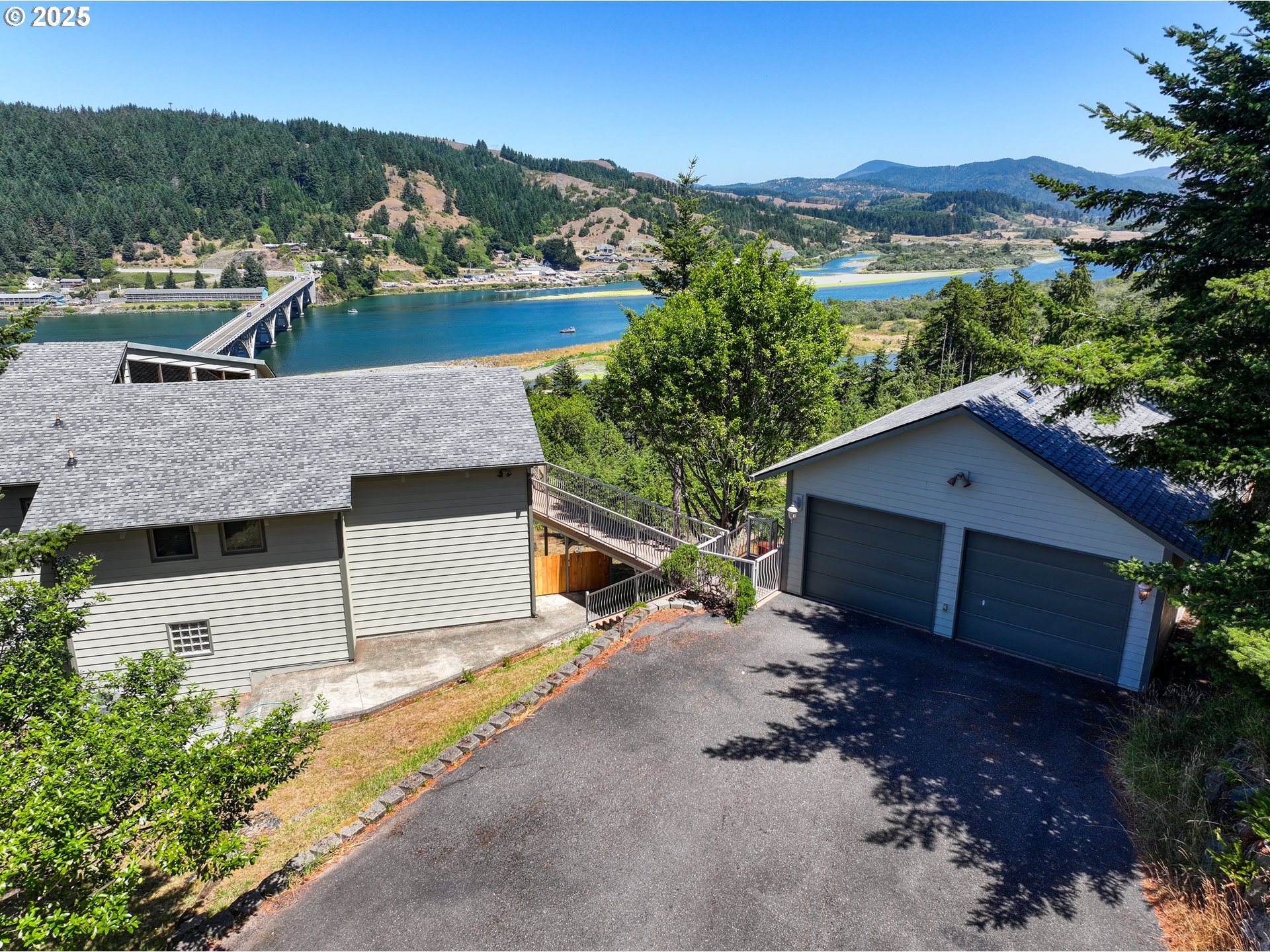 94418 Tom Cat Hill Road Gold Beach, OR 97444 - Photo 39 of 46 an aerial view of a house with a yard and mountain view in back