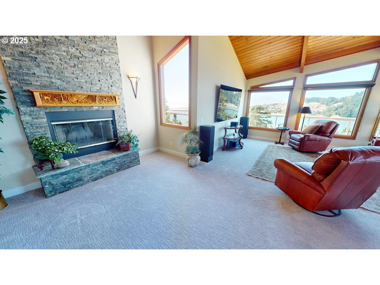 94418 Tom Cat Hill Road Gold Beach, OR 97444 - Photo 7 of 46 a living room with furniture a flat screen tv and a large window