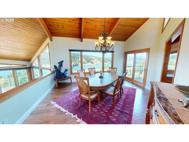 a living room with furniture a chandelier and a dining table