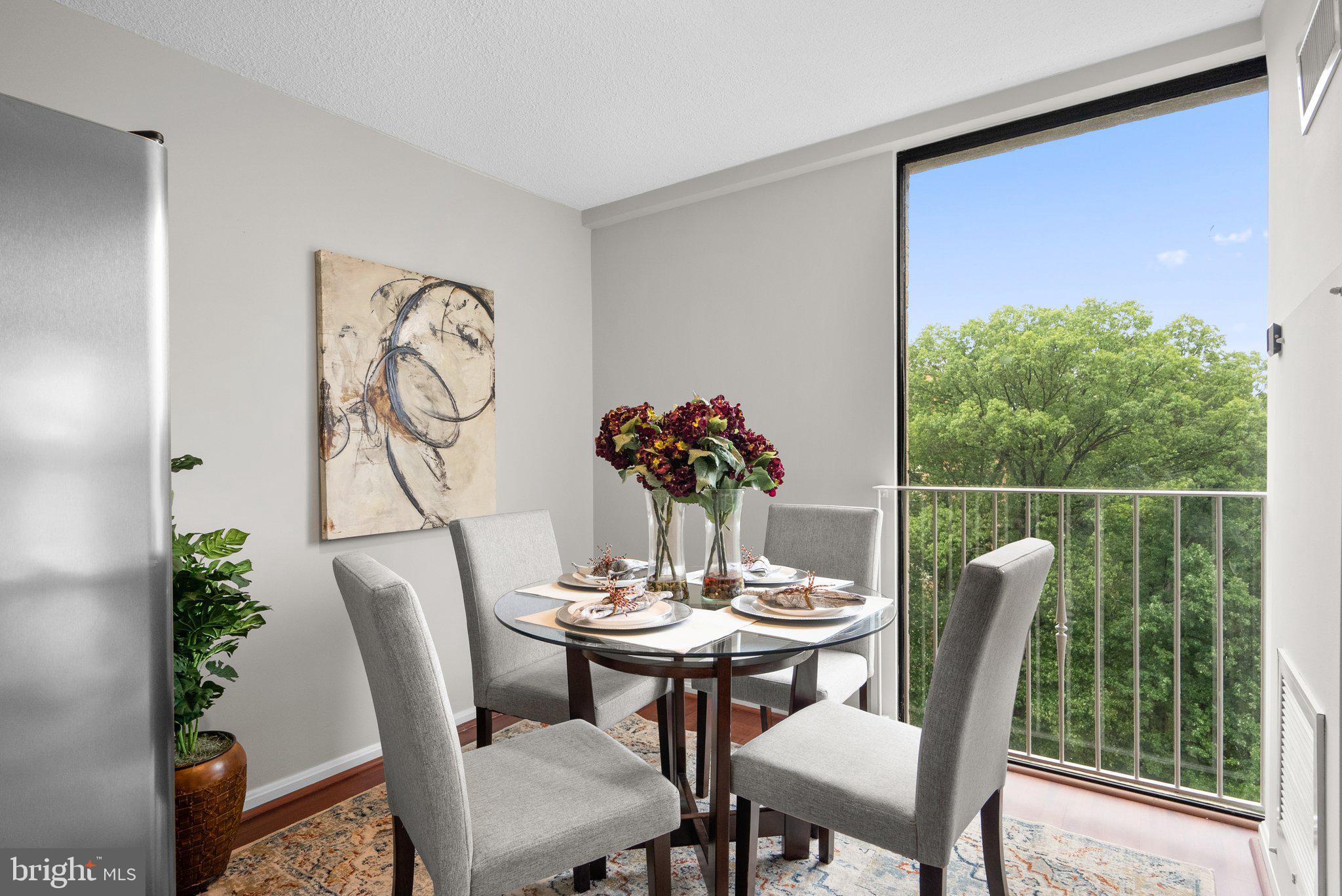 2100 Washington Avenue, Unit 10A Silver Spring, MD 20910 - Photo 11 of 26 a dining room with furniture potted plants and wooden floor