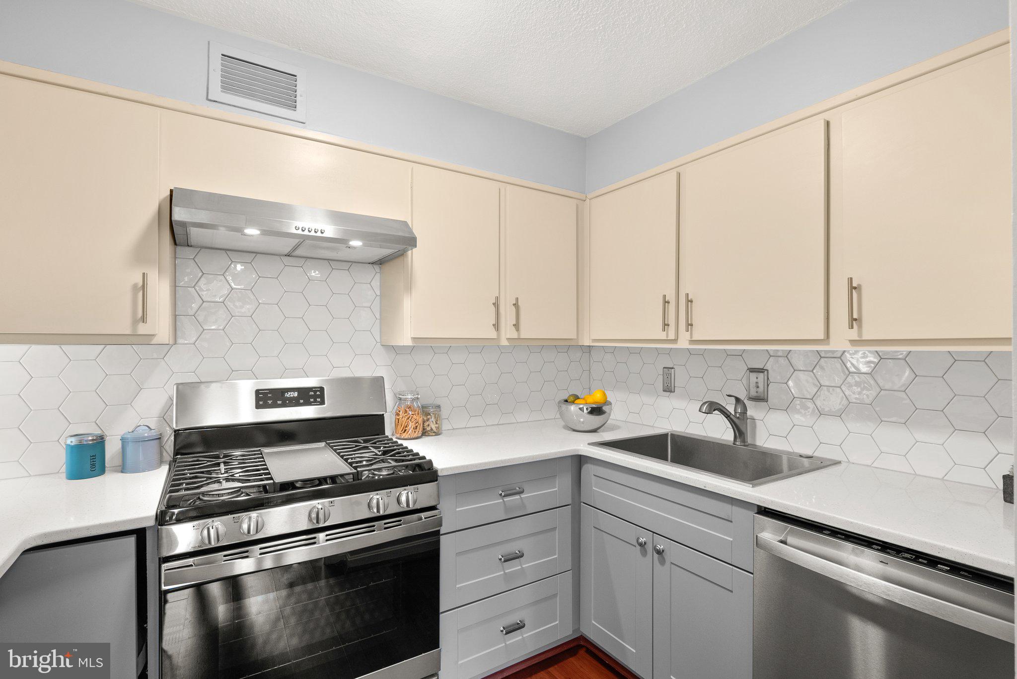 2100 Washington Avenue, Unit 10A Silver Spring, MD 20910 - Photo 12 of 26 a kitchen with white cabinets and appliances