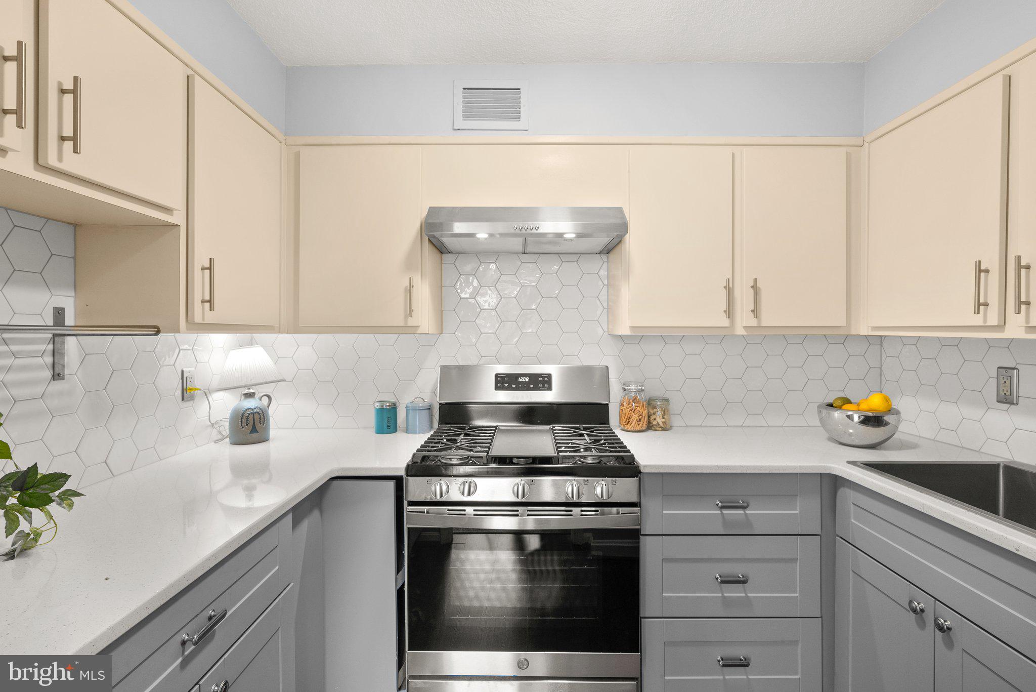 2100 Washington Avenue, Unit 10A Silver Spring, MD 20910 - Photo 13 of 26 a kitchen with white cabinets and appliances