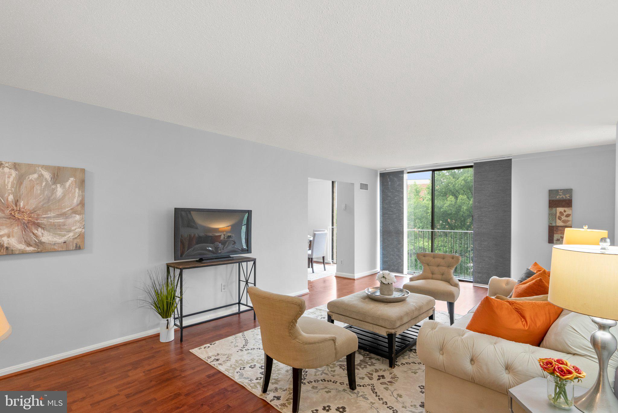 2100 Washington Avenue, Unit 10A Silver Spring, MD 20910 - Photo 7 of 26 a living room with furniture a large window and a flat screen tv
