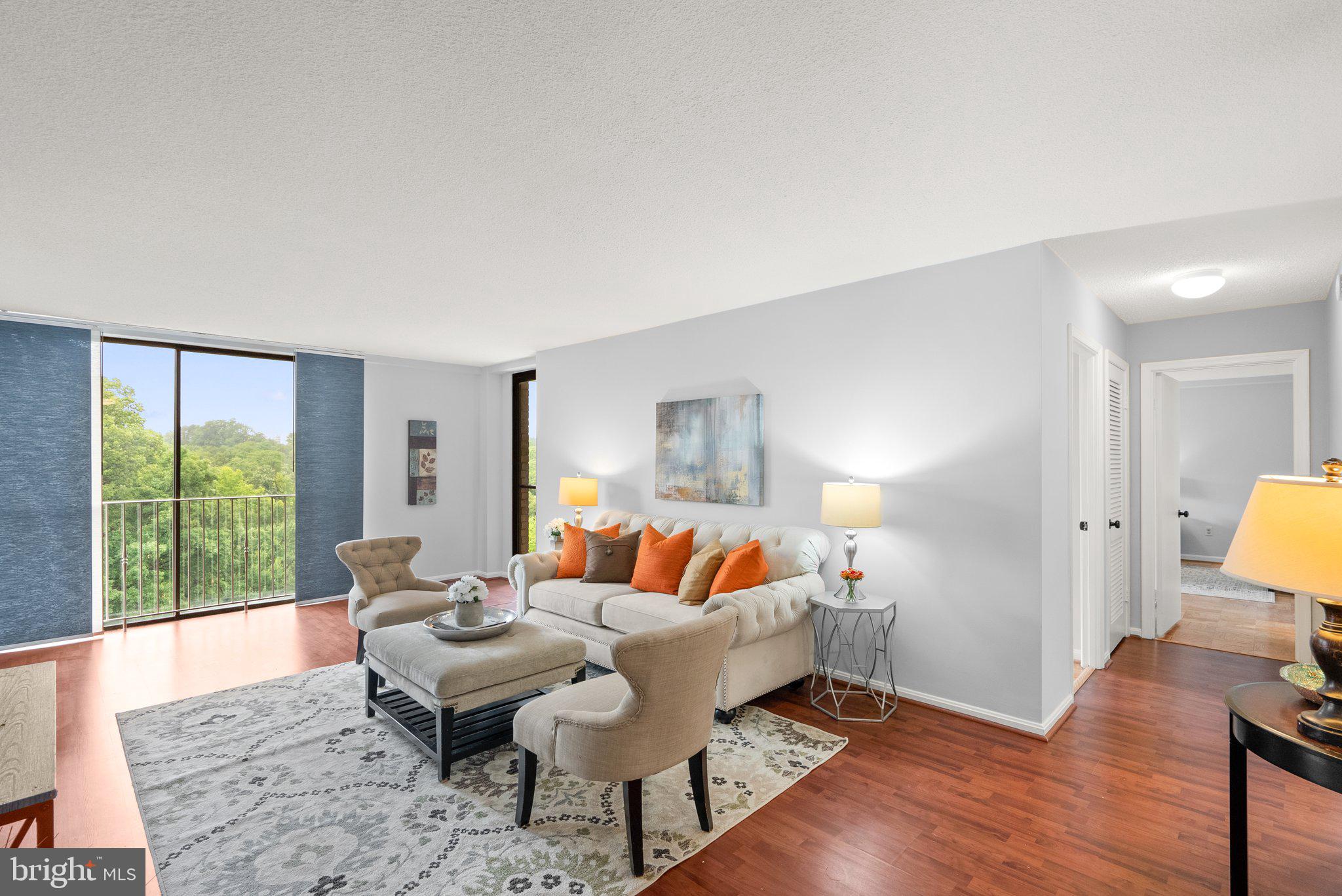 2100 Washington Avenue, Unit 10A Silver Spring, MD 20910 - Photo 10 of 26 a living room with furniture and a lamp with wooden floor