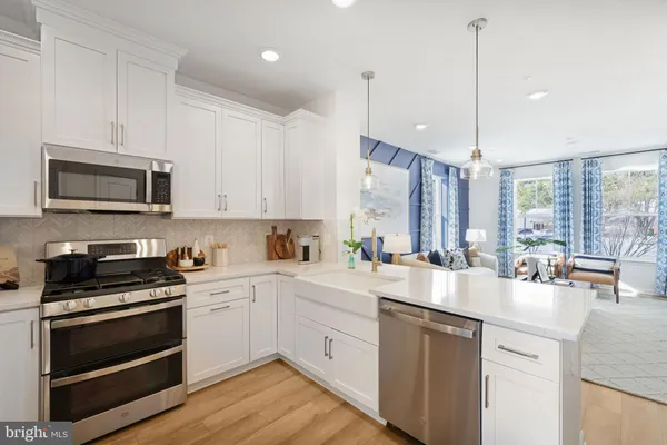 a kitchen with a sink stove and microwave