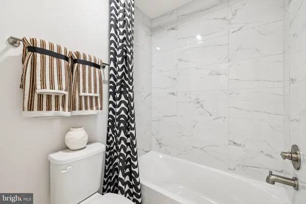 a bathroom with a bathtub and shower