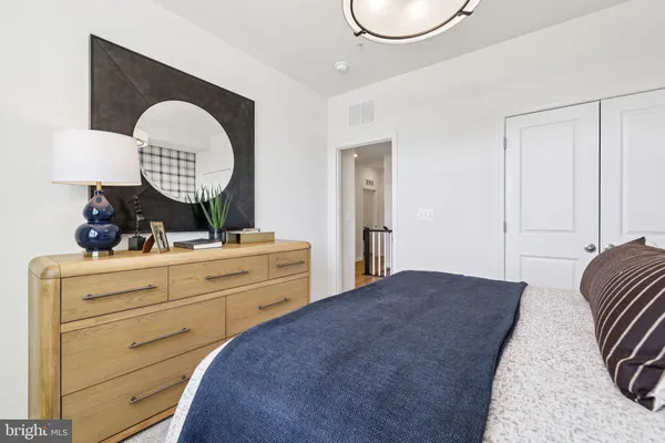 a bedroom with a bed and a mirror