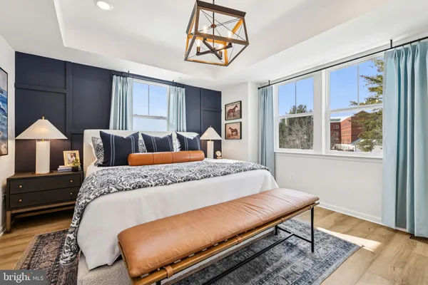 a bed sitting in a bedroom next to a window