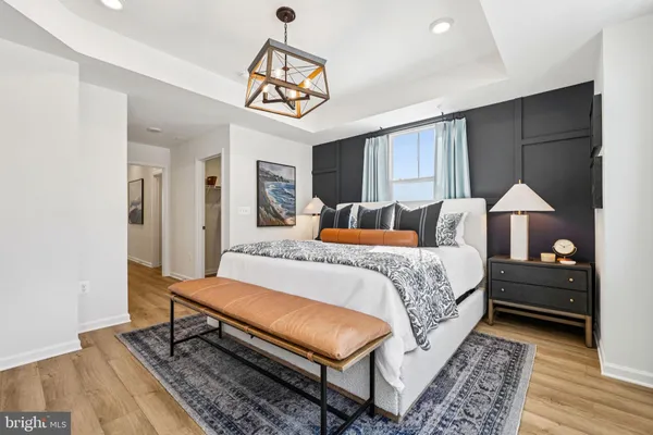 a bedroom with a bed and a chandelier