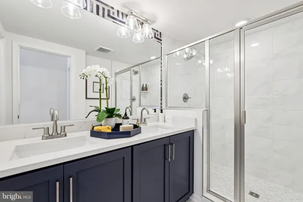 a bathroom with a double vanity sink and a mirror