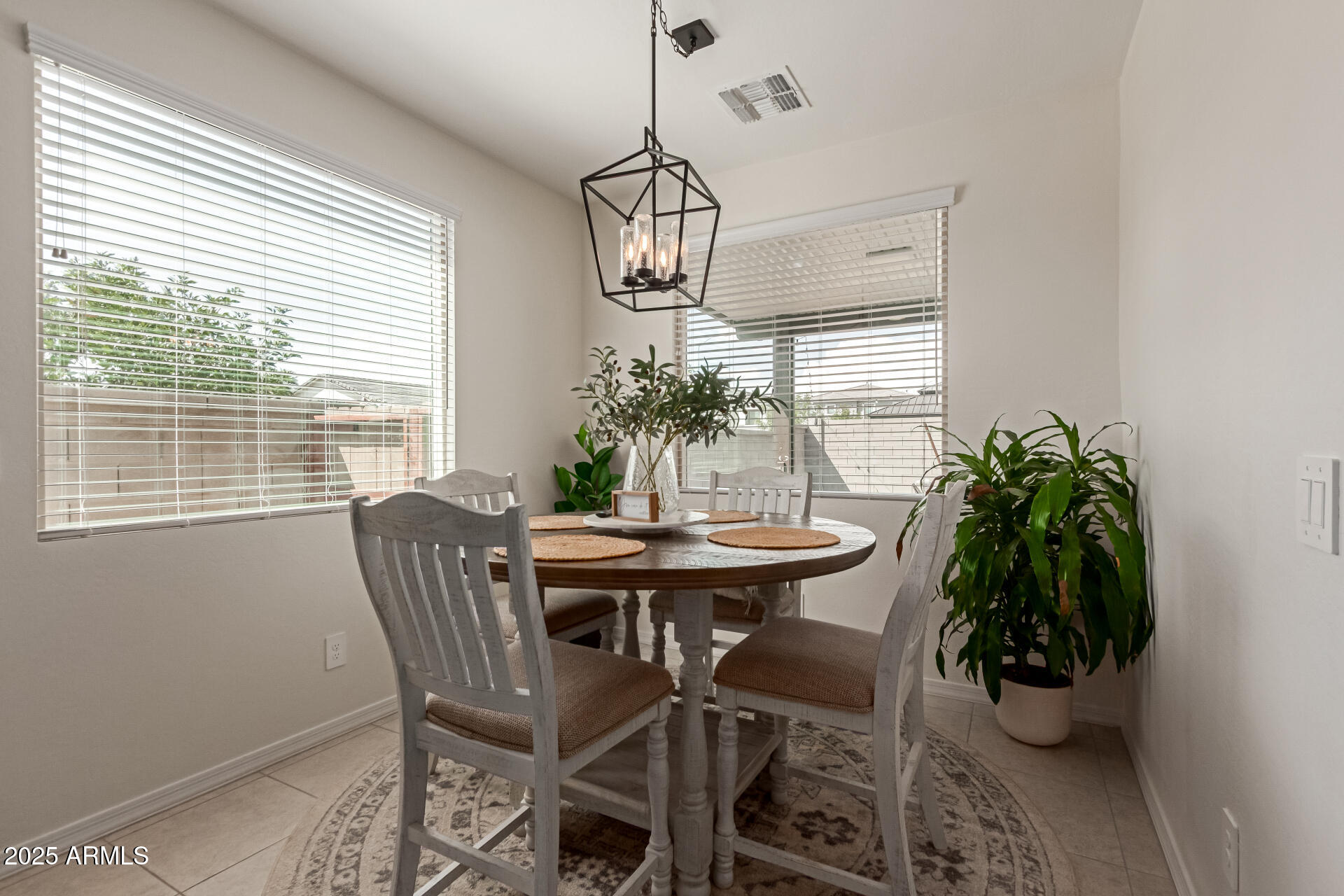 11534 East Unity Avenue Mesa, AZ 85212 - Photo 11 of 22 a view of a dining room with furniture window and wooden floor