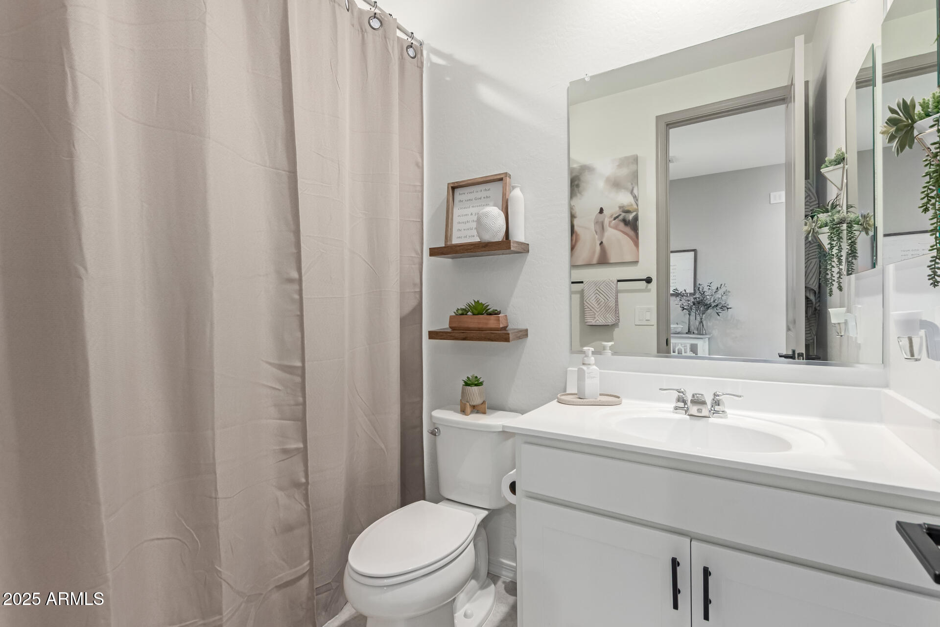 11534 East Unity Avenue Mesa, AZ 85212 - Photo 17 of 22 a bathroom with a sink a toilet and shower curtain