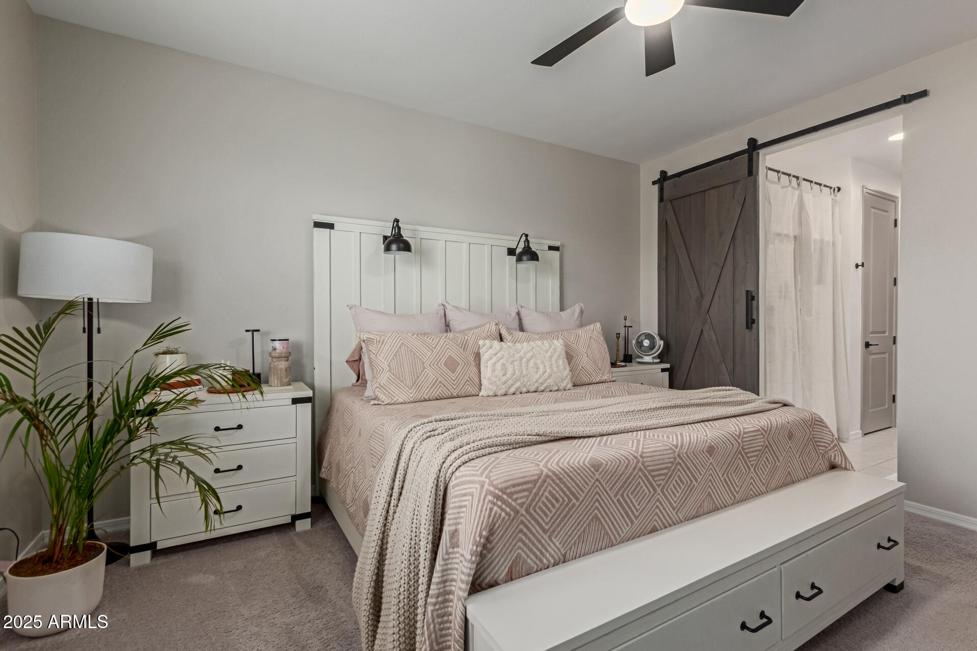 11534 East Unity Avenue Mesa, AZ 85212 - Photo 2 of 22 a bedroom with a bed and a chandelier fan