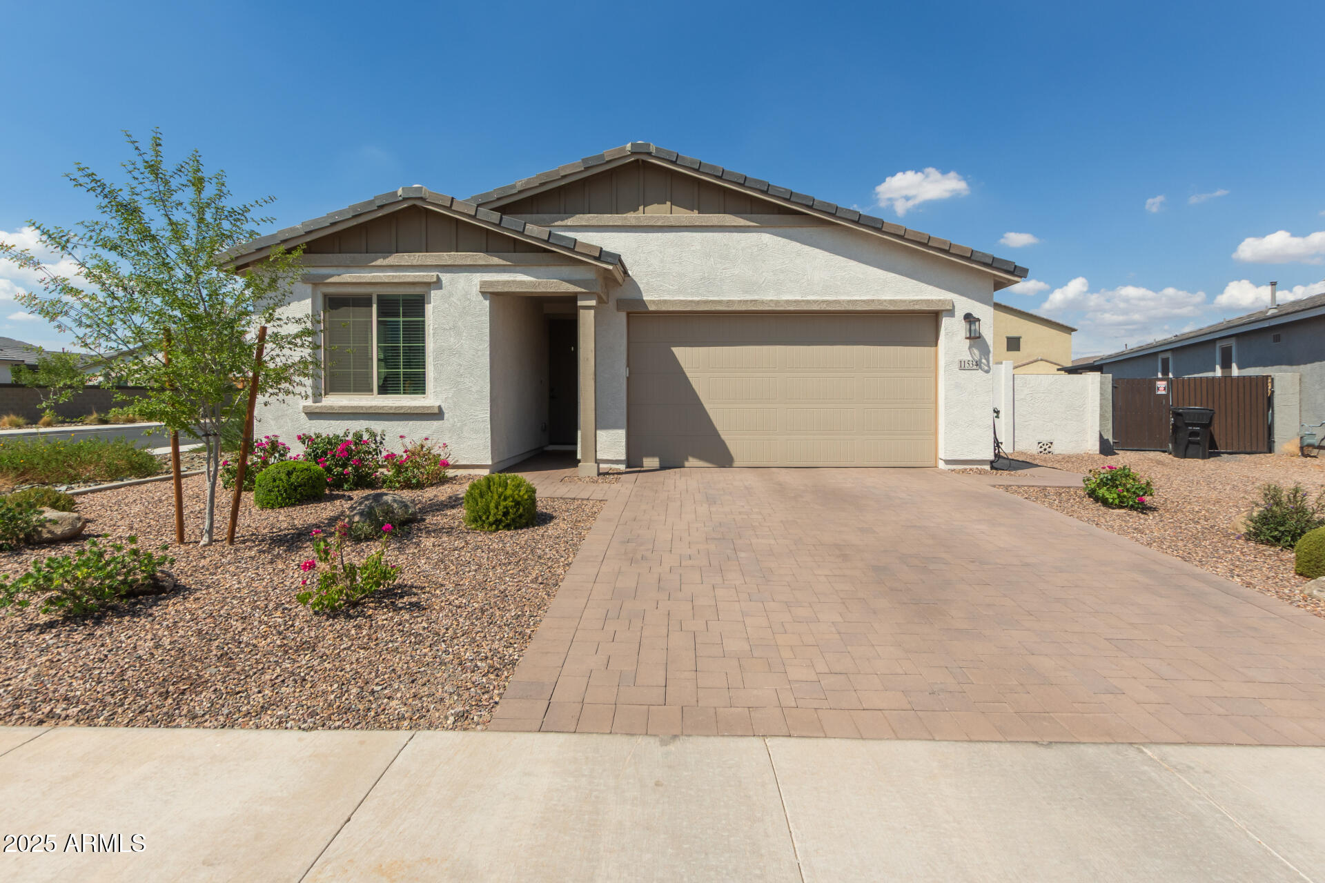 11534 East Unity Avenue Mesa, AZ 85212 - Photo 5 of 22 a front view of a house with a yard and garage