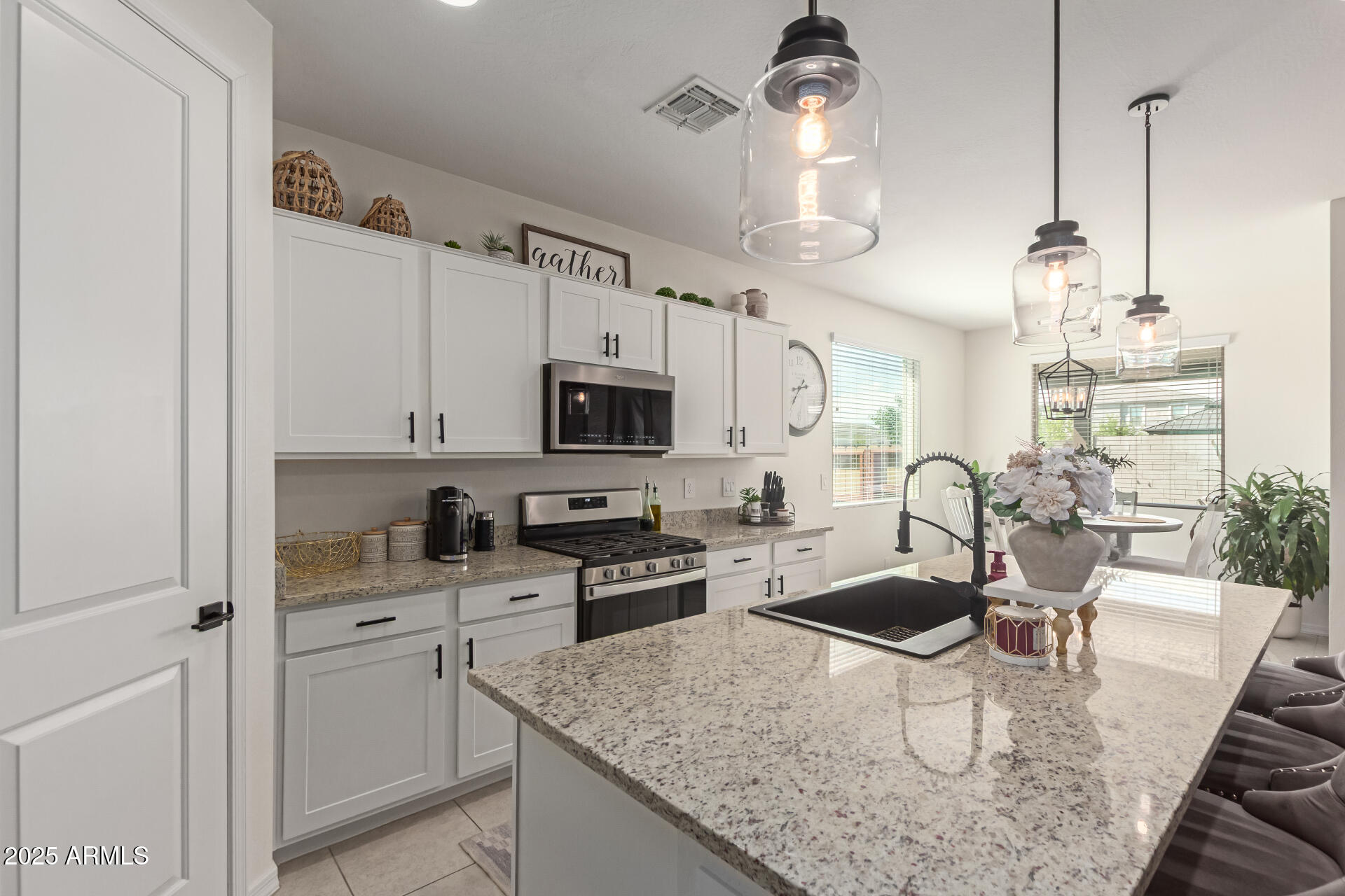11534 East Unity Avenue Mesa, AZ 85212 - Photo 9 of 22 a kitchen with stainless steel appliances granite countertop a sink a stove and cabinets