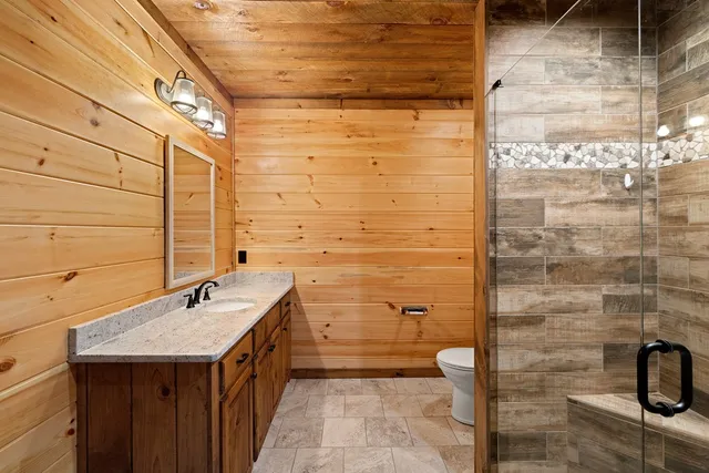 a bathroom with a granite countertop bathtub and sink