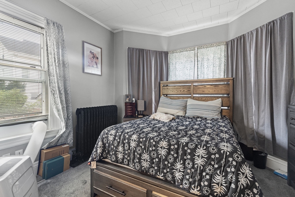 48 Ridge Street Fall River, MA 02721 - Photo 20 of 39 a bedroom with a bed and wooden floor