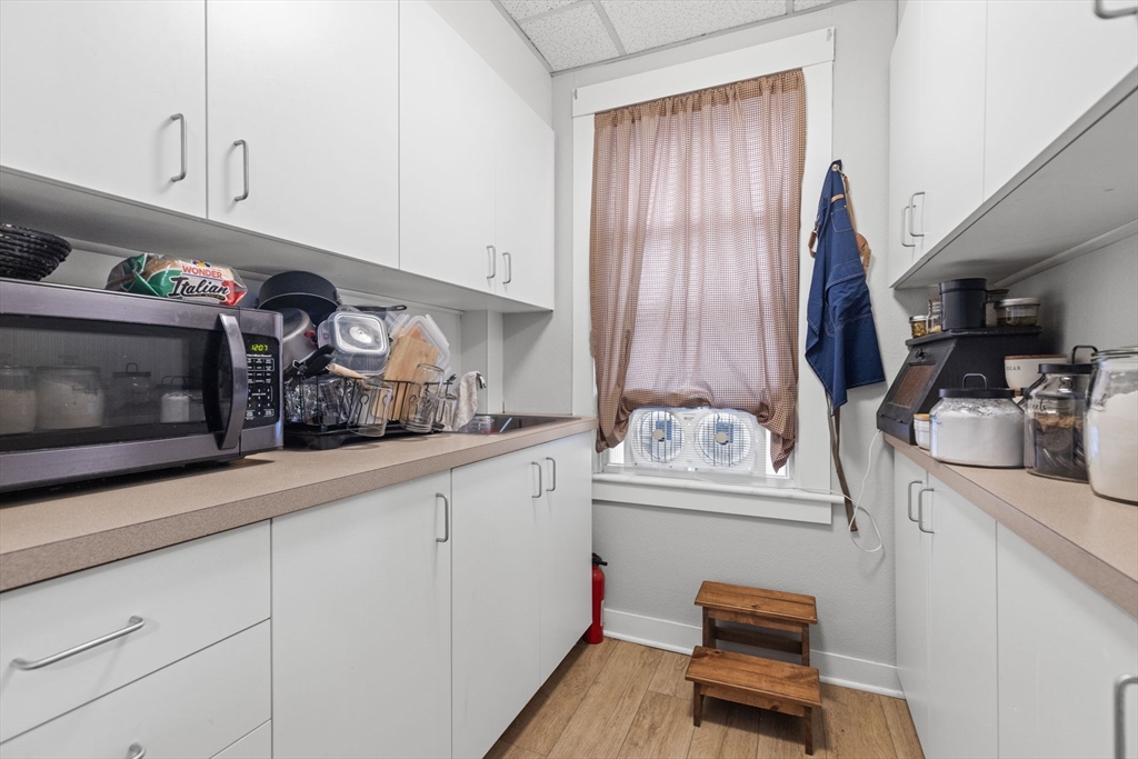 48 Ridge Street Fall River, MA 02721 - Photo 22 of 39 a kitchen with cabinets and window