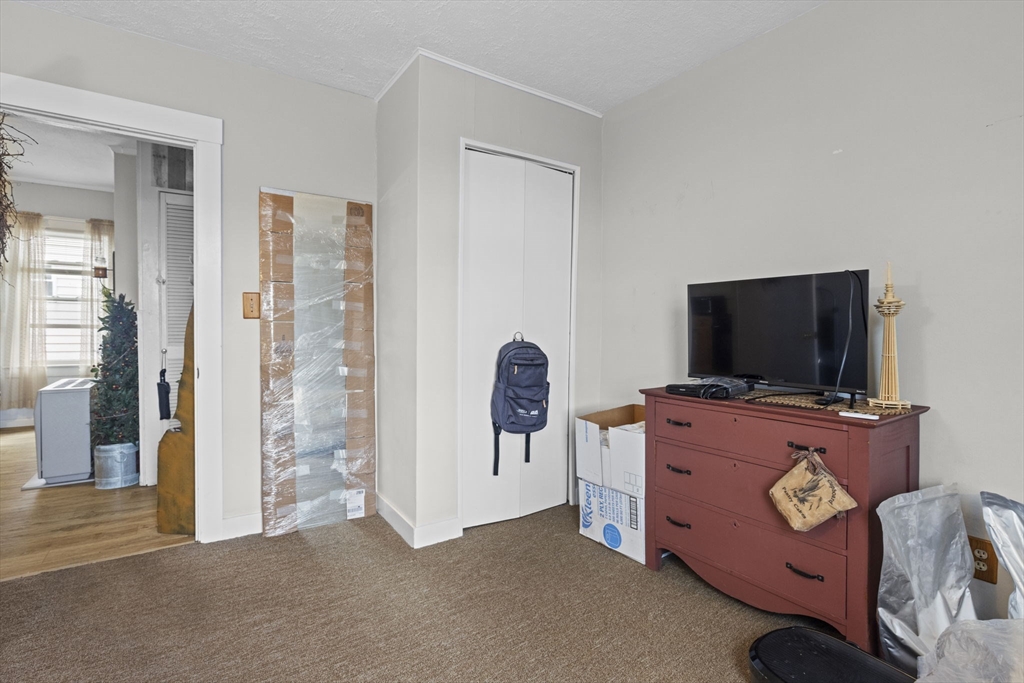 48 Ridge Street Fall River, MA 02721 - Photo 25 of 39 a living room with furniture and a flat screen tv