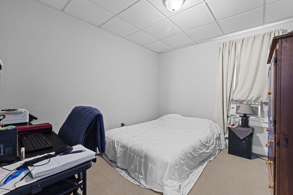 48 Ridge Street Fall River, MA 02721 - Photo 27 of 39 a bedroom with a bed chair and a window