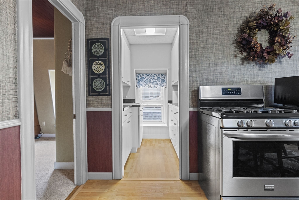 48 Ridge Street Fall River, MA 02721 - Photo 29 of 39 a kitchen with a stove and a refrigerator