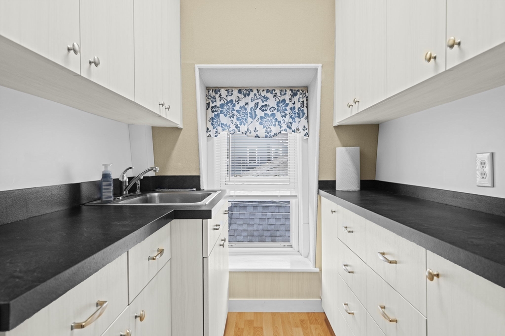 48 Ridge Street Fall River, MA 02721 - Photo 30 of 39 a kitchen with granite countertop a sink stove and cabinets