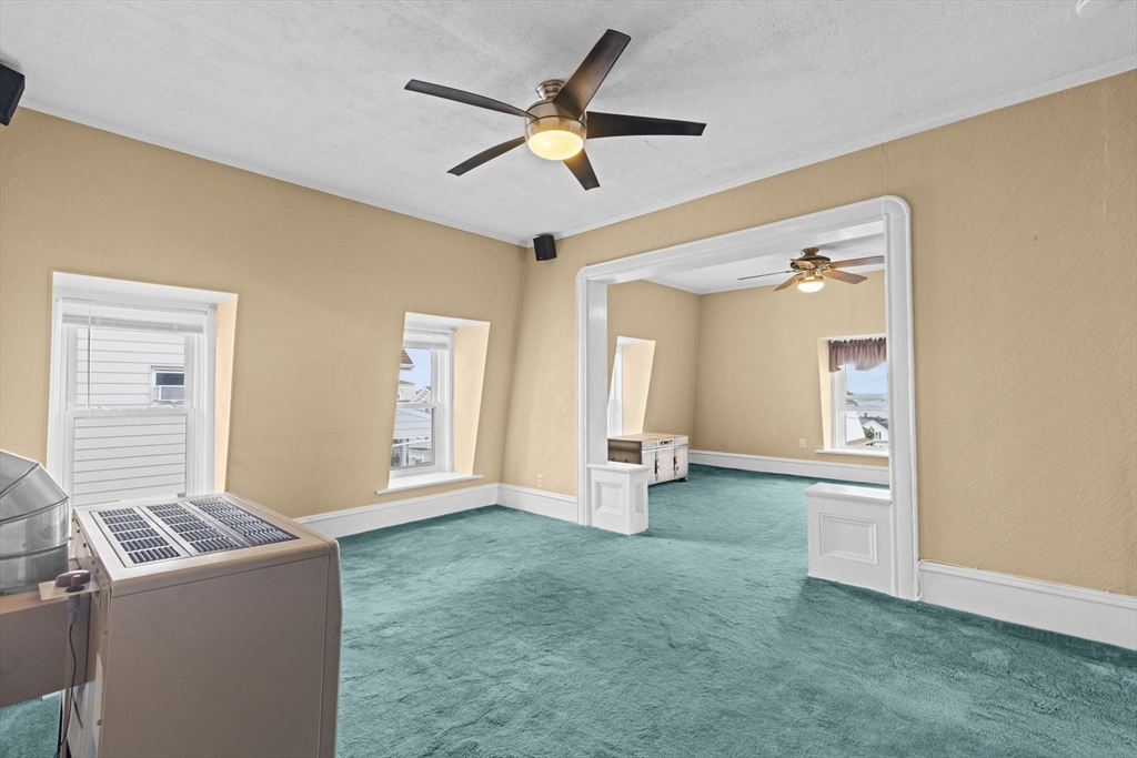 48 Ridge Street Fall River, MA 02721 - Photo 35 of 39 a living room with a couch and a ceiling fan