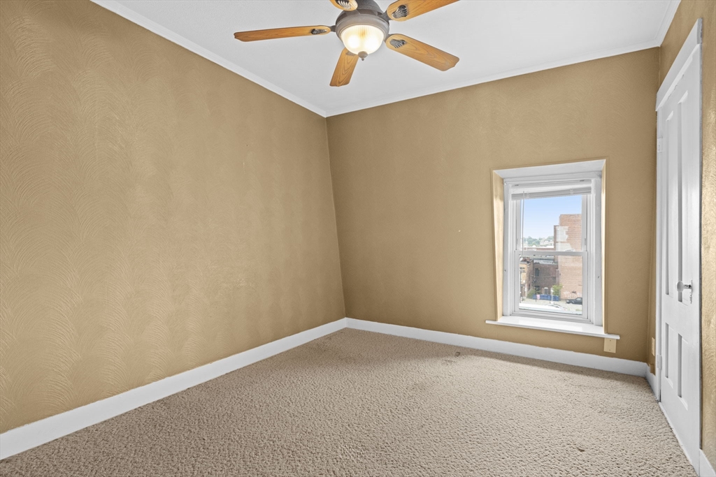 48 Ridge Street Fall River, MA 02721 - Photo 37 of 39 an empty room with windows and fan