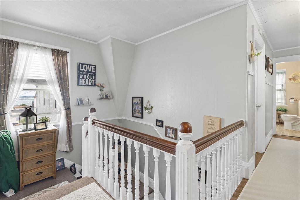 48 Ridge Street Fall River, MA 02721 - Photo 7 of 39 a view of a bedroom with baby crib and a window