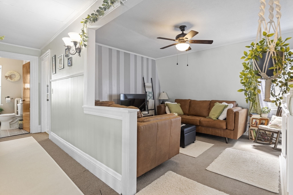 48 Ridge Street Fall River, MA 02721 - Photo 8 of 39 a living room with furniture and a chandelier