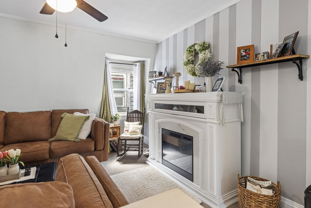 48 Ridge Street Fall River, MA 02721 - Photo 9 of 39 a living room with furniture and a fireplace