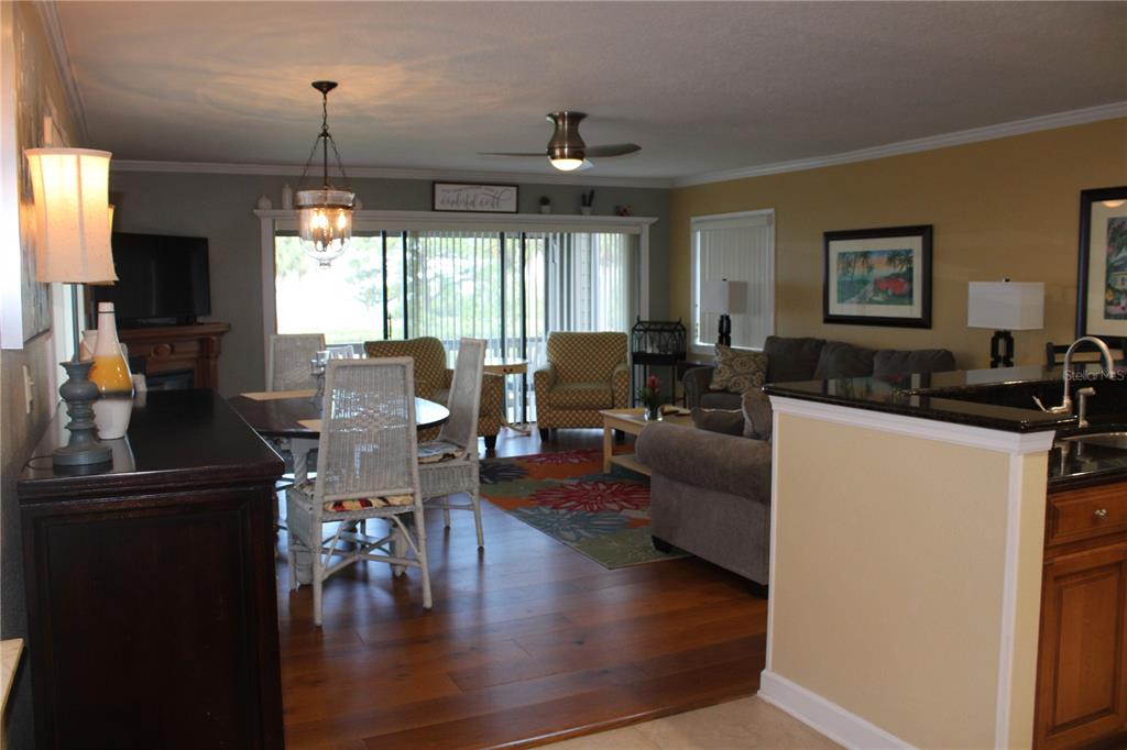 335 Windrush Loop, Unit 335 Tarpon Springs, FL 34689 - Photo 2 of 18 a living room with furniture and a flat screen tv