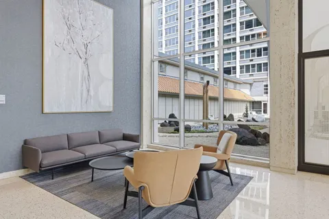 a view of a livingroom with furniture and a window