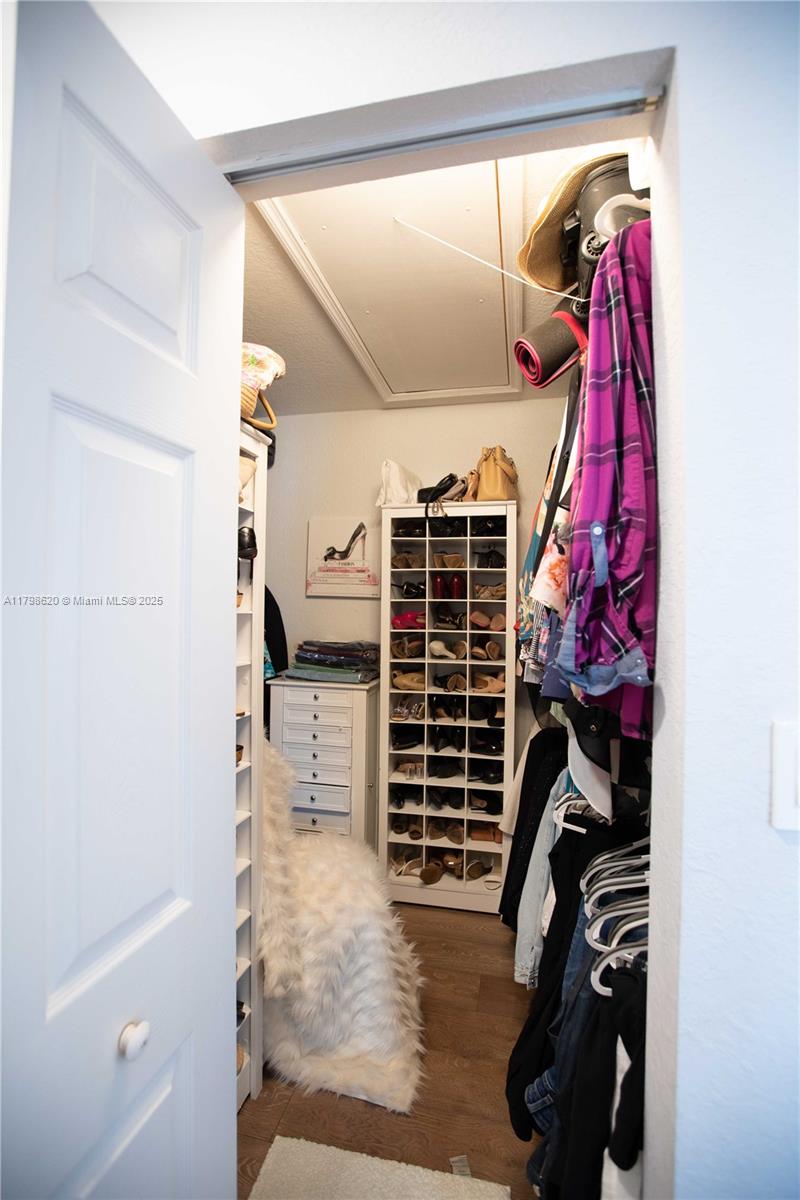 4450 Laurel Place Weston, FL 33332 - Photo 27 of 46 a view of walk in closet with clothes and shoes