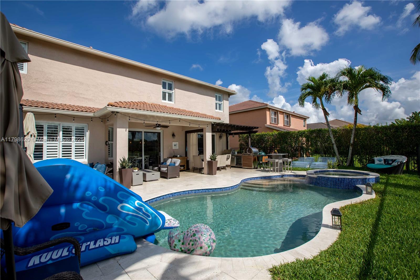 4450 Laurel Place Weston, FL 33332 - Photo 36 of 46 a view of a house with swimming pool patio and swimming pool