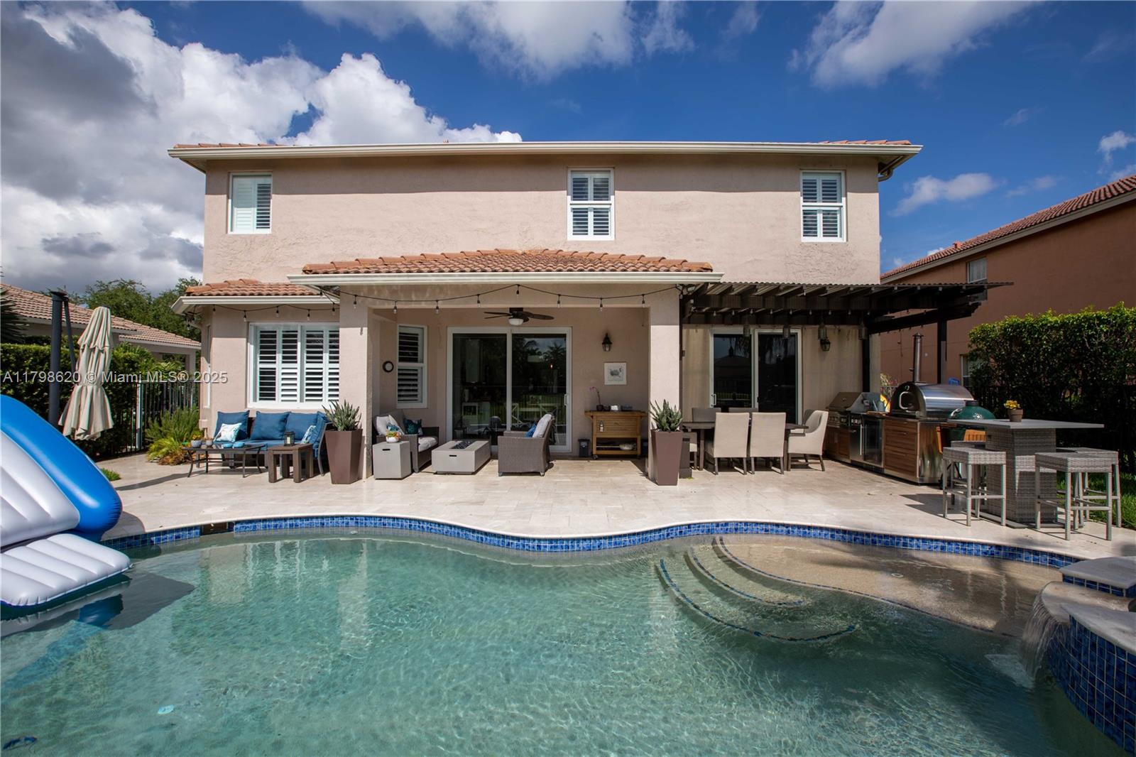 4450 Laurel Place Weston, FL 33332 - Photo 37 of 46 a view of a house with pool and chairs