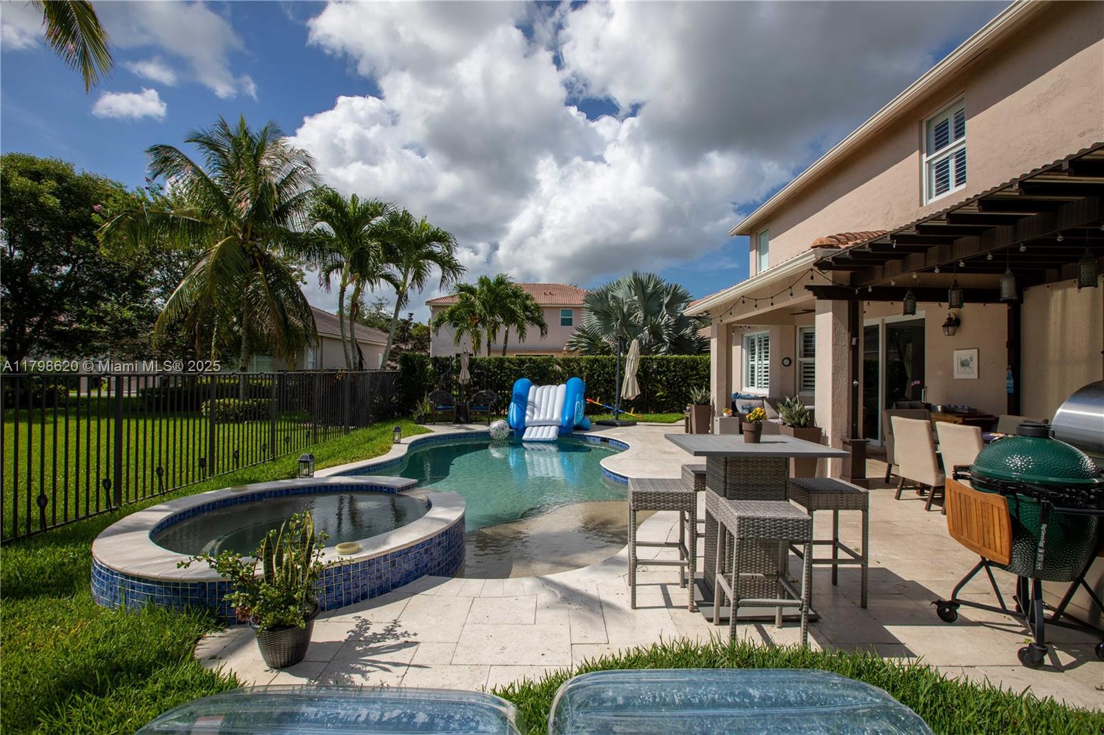 4450 Laurel Place Weston, FL 33332 - Photo 38 of 46 a view of a house with backyard sitting area and garden