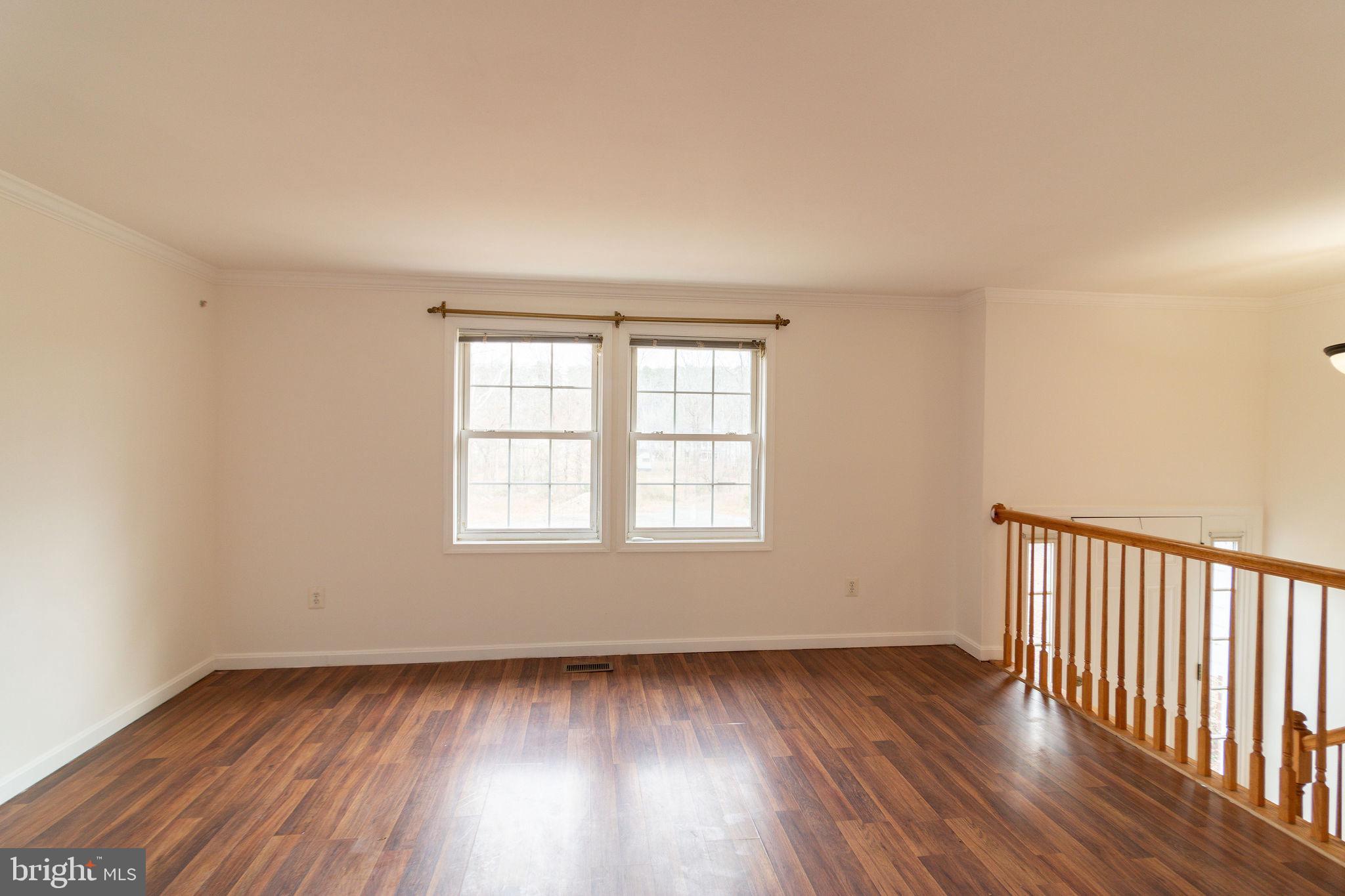 16 Eley Road Fredericksburg, VA 22406 - Photo 2 of 16 an empty room with wooden floor and windows