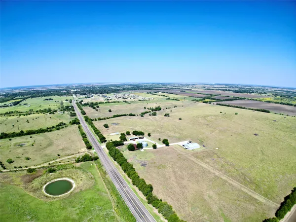 an aerial view of residential house with outdoor space and parking