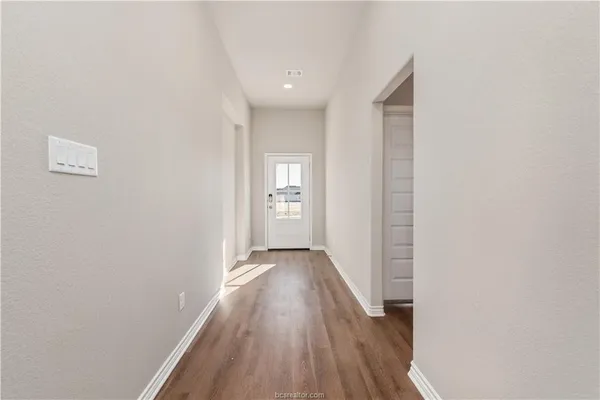 a view of hallway with wooden floor