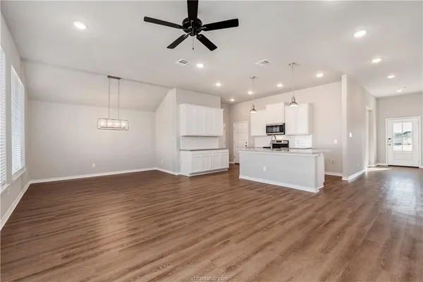 a view of kitchen with refrigerator microwave and stove