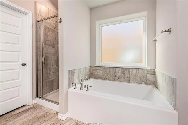 a white bath tub sitting next to a shower