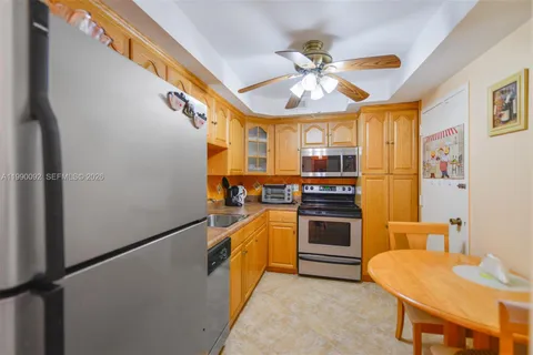 a kitchen with stainless steel appliances a stove a sink dishwasher and a refrigerator