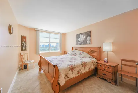 a bedroom with a bed a table and chair