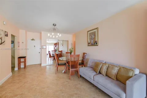 a living room with furniture and a dining table