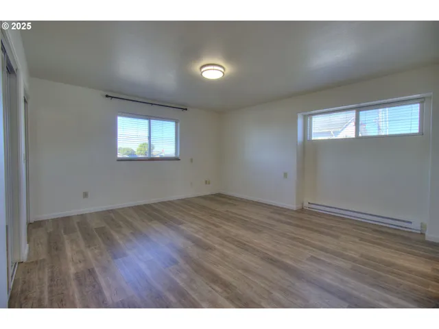 a view of an empty room and wooden floor