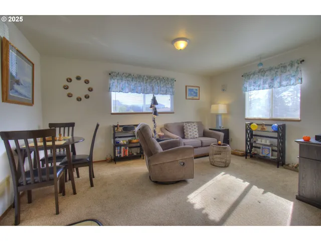 a living room with furniture and a dining table